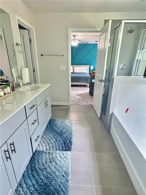 283 Wells Cir, Canton, GA 30114 - full bath with a shower stall, vanity, a garden tub, tile patterned flooring, and a ceiling fan