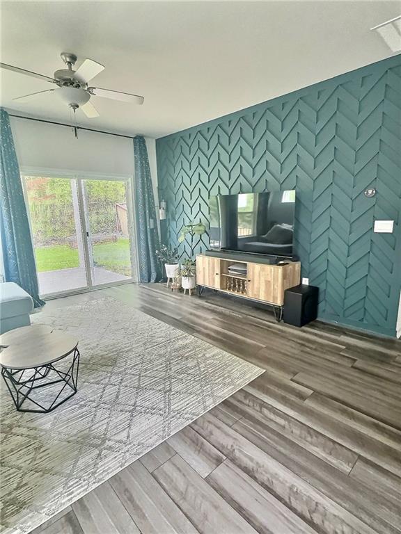 283 Wells Cir, Canton, GA 30114 - unfurnished living room with wood finished floors and ceiling fan