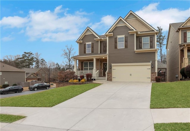 craftsman-style home with a garage, covered porch, and a front lawn