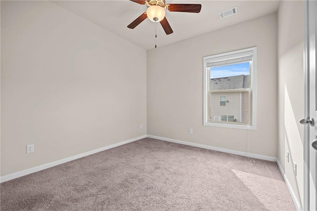 spare room with a ceiling fan, carpet flooring, visible vents, and baseboards