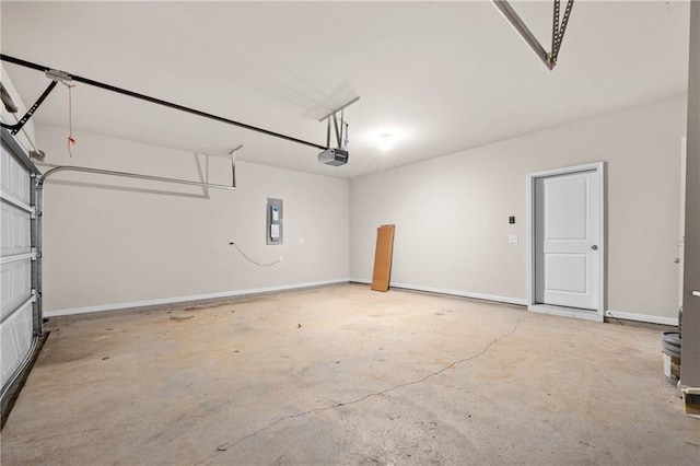 garage featuring baseboards, electric panel, and a garage door opener