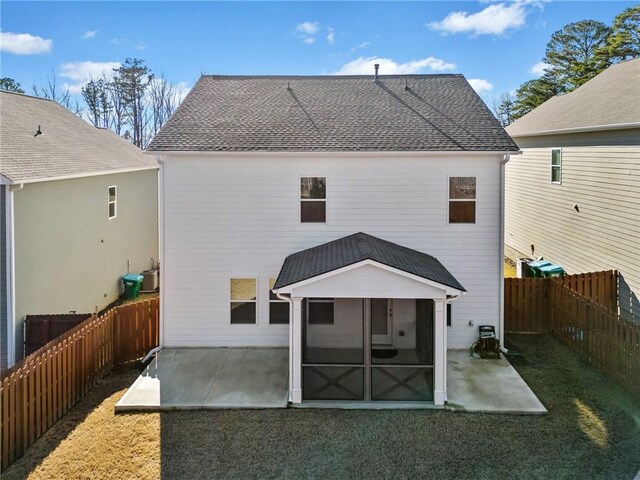 rear view of property with a patio and a sunroom