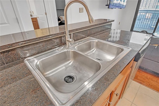 details featuring dark stone countertops and sink