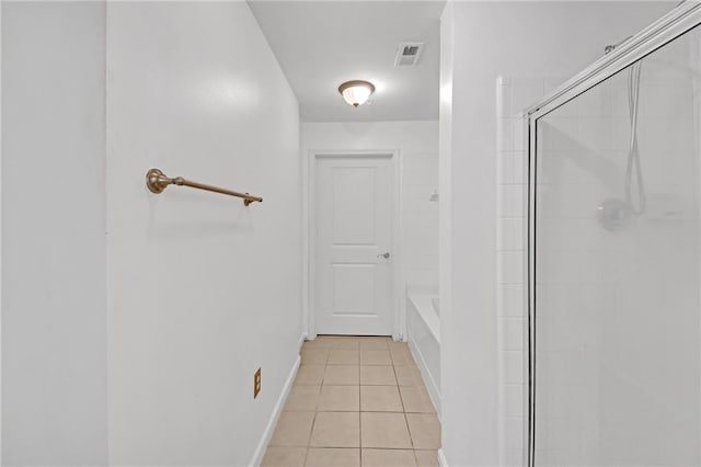 bathroom with tile patterned flooring and shower with separate bathtub