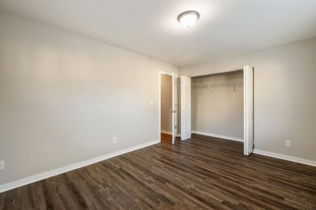 hall featuring baseboards and wood finished floors