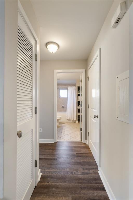 laundry room featuring dark wood-style floors, baseboards, hookup for a washing machine, and hookup for an electric dryer