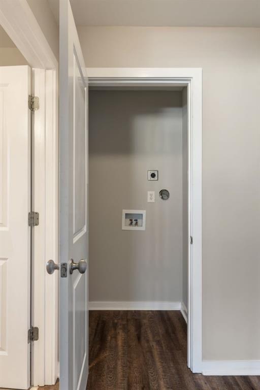 interior space with dark wood-style floors, baseboards, and visible vents