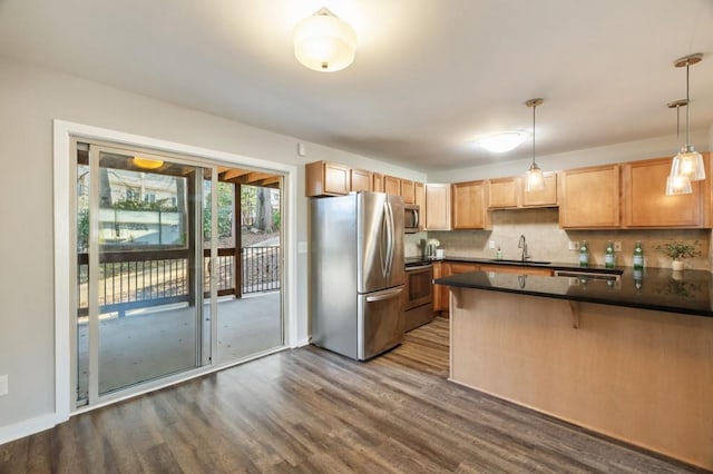 kitchen with dark countertops, dark wood-style floors, tasteful backsplash, and stainless steel appliances