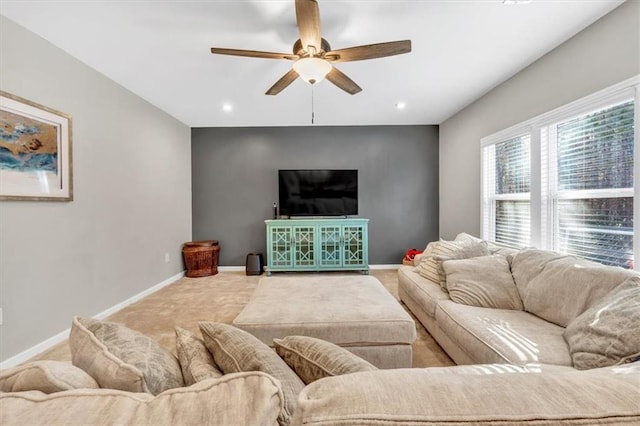 carpeted living room with ceiling fan