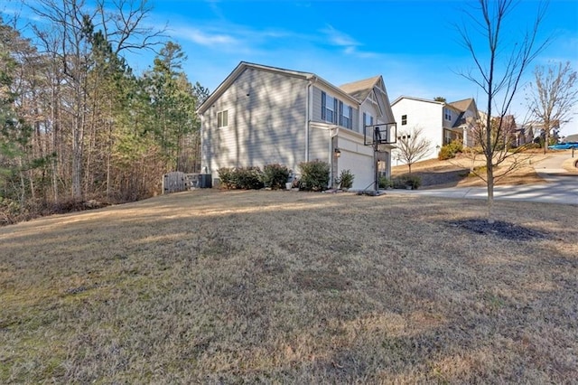 view of side of home with a yard and a garage