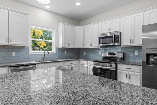 kitchen with sink, appliances with stainless steel finishes, and white cabinets