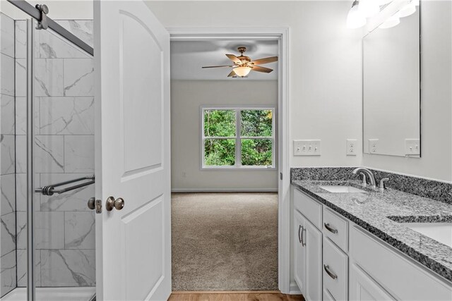 bathroom featuring vanity, an enclosed shower, and ceiling fan