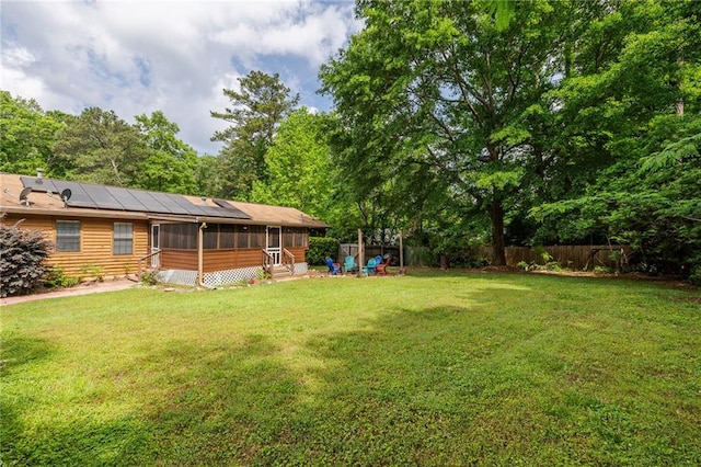 view of yard with a sunroom and fence