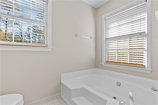6165 Picketts Rdg NW, Acworth, GA 30101 - bathroom featuring toilet, a bath, baseboards, and tile patterned flooring