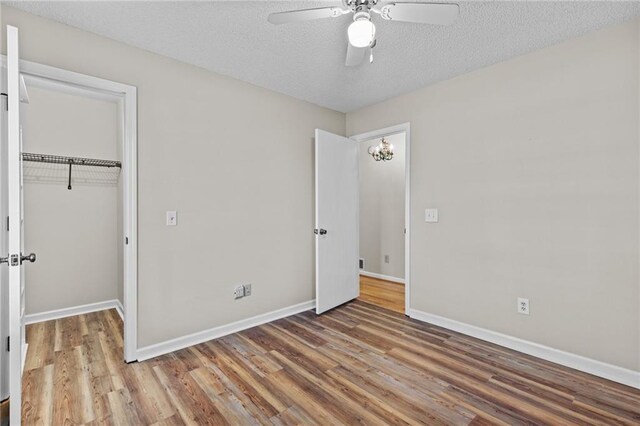 6165 Picketts Rdg NW, Acworth, GA 30101 - unfurnished bedroom featuring a ceiling fan, wood finished floors, baseboards, a closet, and a textured ceiling