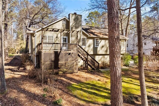 6165 Picketts Rdg NW, Acworth, GA 30101 - back of property featuring a wooden deck, stairway, and a chimney