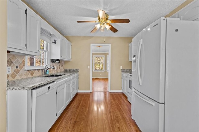 6165 Picketts Rdg NW, Acworth, GA 30101 - kitchen with a sink, backsplash, white cabinetry, white appliances, and ceiling fan