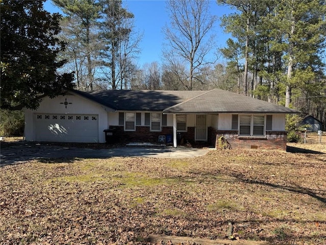 ranch-style house featuring driveway, brick siding, and an attached garage