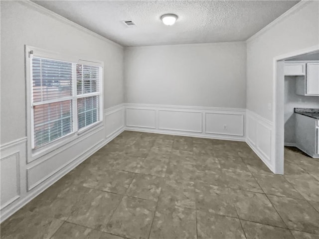 unfurnished room with a textured ceiling