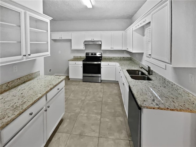 kitchen with stainless steel appliances, light stone countertops, sink, and white cabinets