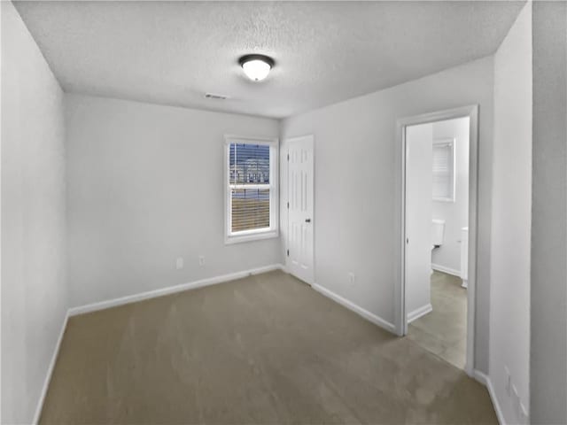 unfurnished bedroom featuring carpet floors and a textured ceiling