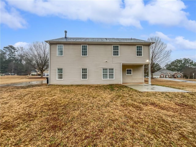 back of property featuring a yard and a patio area