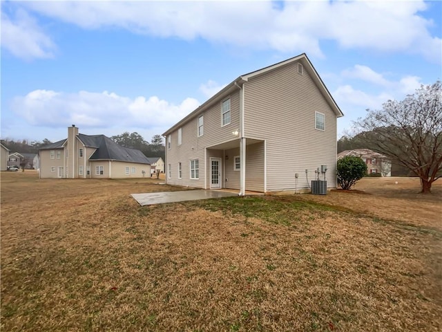 rear view of house with a yard, a patio area, and central air condition unit