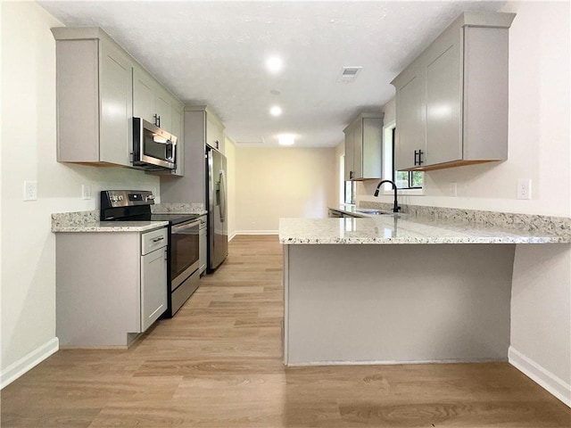 2140 Fern Valley Dr SW, Atlanta, GA 30331 - kitchen featuring appliances with stainless steel finishes, gray cabinets, kitchen peninsula, and sink