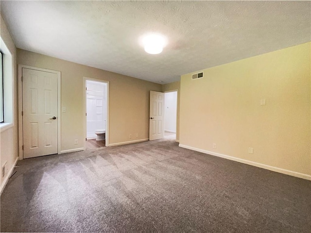 2140 Fern Valley Dr SW, Atlanta, GA 30331 - unfurnished bedroom featuring carpet flooring, a textured ceiling, and ensuite bath