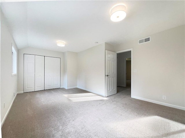 2140 Fern Valley Dr SW, Atlanta, GA 30331 - unfurnished bedroom with carpet floors, a closet, and vaulted ceiling