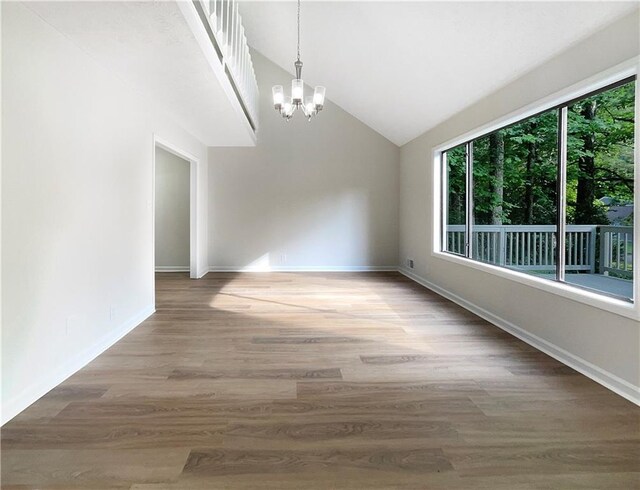 2140 Fern Valley Dr SW, Atlanta, GA 30331 - unfurnished dining area with wood-type flooring, a chandelier, and vaulted ceiling
