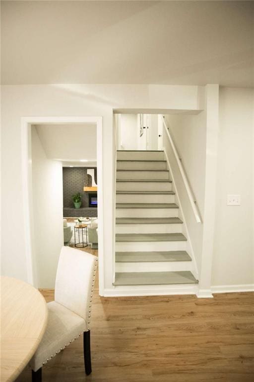 stairway with hardwood / wood-style floors