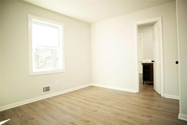 spare room featuring wood-type flooring