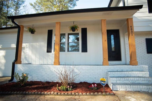 property entrance with a garage and a porch