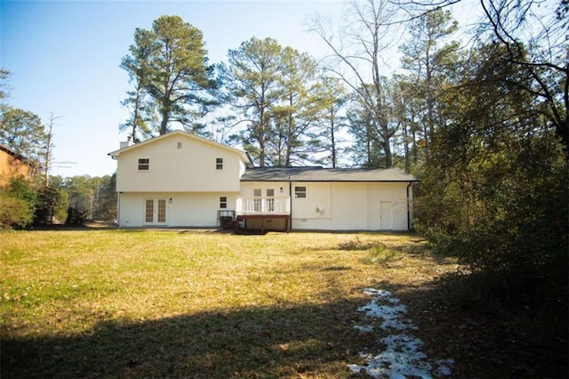 back of house with a lawn and french doors