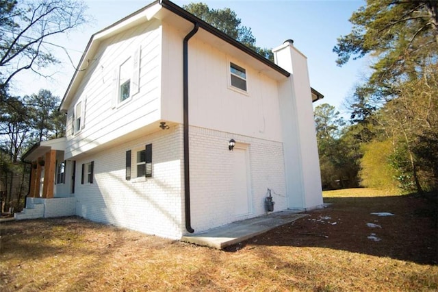 view of side of home featuring a lawn