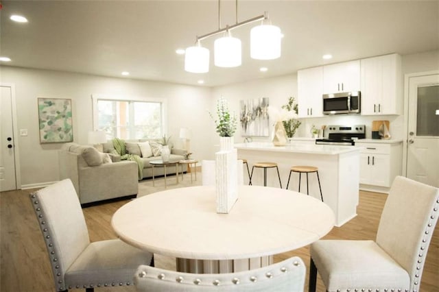 dining space with light hardwood / wood-style floors