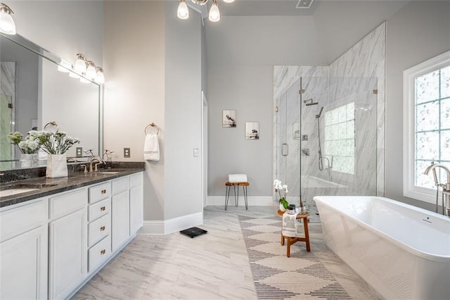 full bathroom with a shower stall, a soaking tub, double vanity, marble look tile flooring, and baseboards