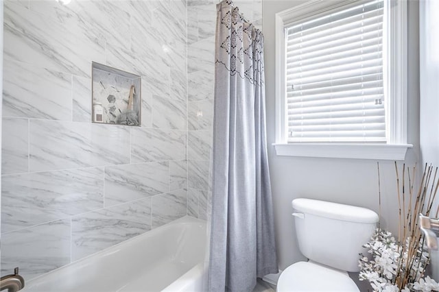 bathroom with shower / tub combo with curtain and toilet