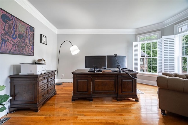 office space with ornamental molding, light wood finished floors, and baseboards