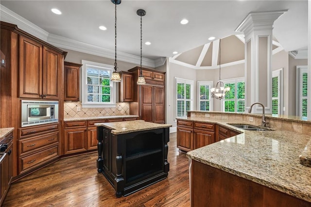 771 Tate Overlook, Marietta, GA 30064 - kitchen featuring a sink, stainless steel microwave, decorative backsplash, a chandelier, and light stone countertops