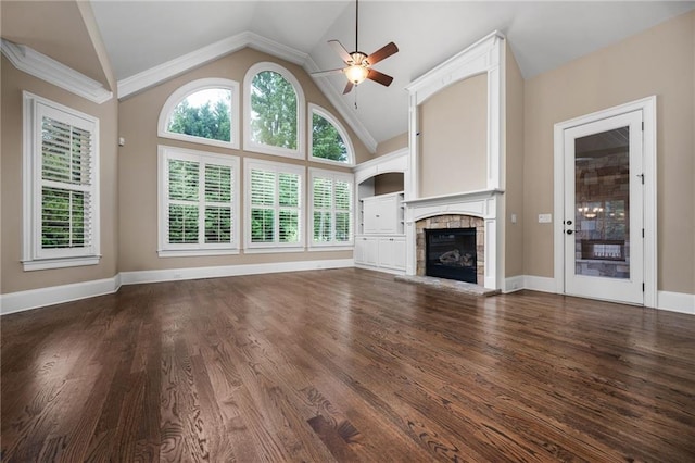 771 Tate Overlook, Marietta, GA 30064 - unfurnished living room with a stone fireplace, a ceiling fan, dark wood-style floors, baseboards, and high vaulted ceiling