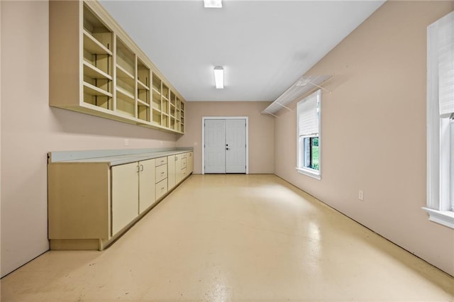 771 Tate Overlook, Marietta, GA 30064 - kitchen featuring light countertops, concrete flooring, and glass insert cabinets