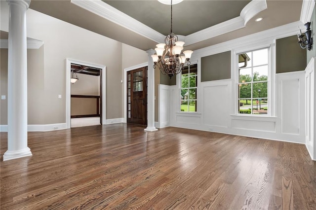 771 Tate Overlook, Marietta, GA 30064 - unfurnished dining area with ornamental molding, decorative columns, a decorative wall, a chandelier, and a tray ceiling