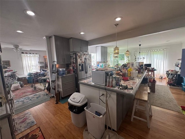 713 Pine Chase Ct, Lawrenceville, GA 30043 - kitchen featuring stainless steel refrigerator with ice dispenser, gray cabinetry, open floor plan, wood finished floors, and recessed lighting