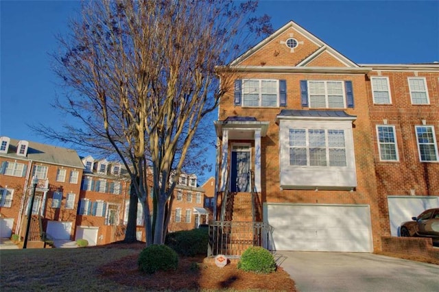 401 Iona Abbey Ct Unit 6, Smyrna, GA 30082 - view of property featuring a garage, brick siding, and driveway