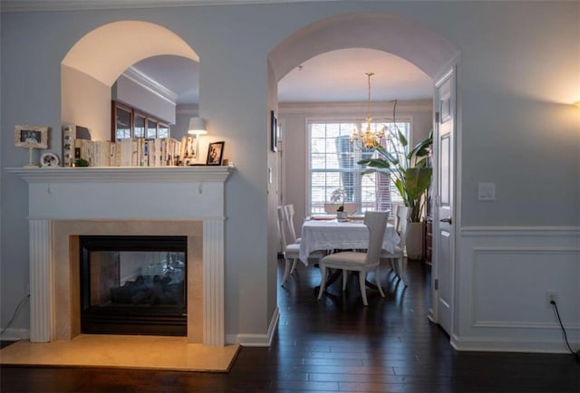 401 Iona Abbey Ct Unit 6, Smyrna, GA 30082 - dining space with dark wood finished floors, a multi sided fireplace, a chandelier, ornamental molding, and arched walkways