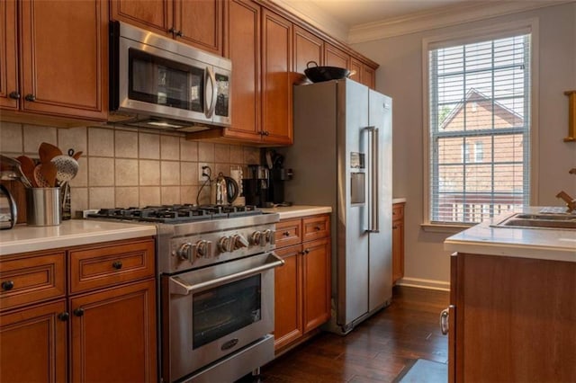 401 Iona Abbey Ct Unit 6, Smyrna, GA 30082 - kitchen featuring stainless steel appliances, brown cabinets, ornamental molding, and dark wood-style floors