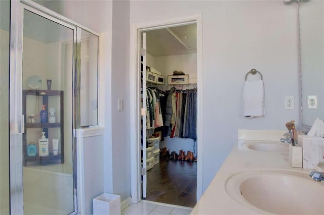 401 Iona Abbey Ct Unit 6, Smyrna, GA 30082 - full bathroom featuring a shower stall, double vanity, a walk in closet, and tile patterned flooring