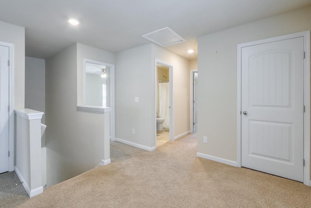 hallway with recessed lighting, baseboards, light colored carpet, and an upstairs landing